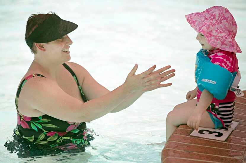 
Jennifer Fernberg encourages her 2-year-old daughter, Brinlee, to test the waters at the...
