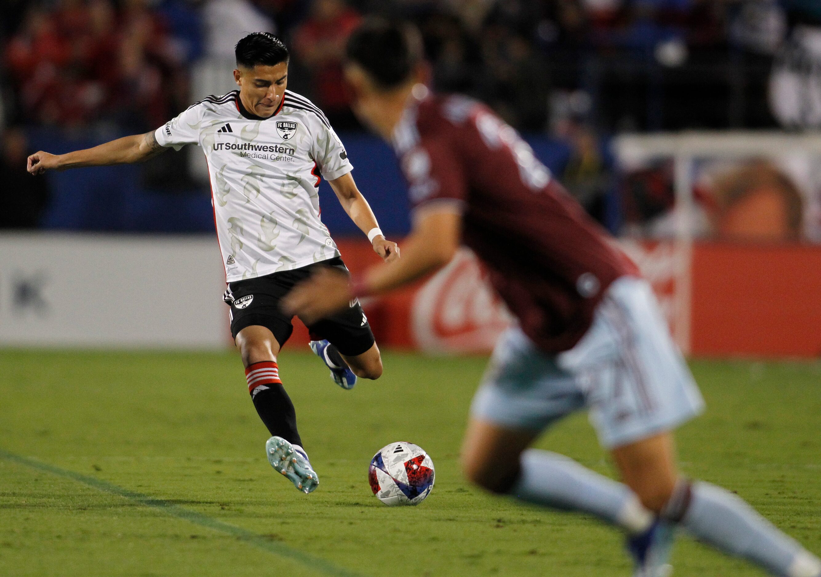 FC Dallas defender Marco Farfan (4) drives the ball against the Colorado rapids defense...