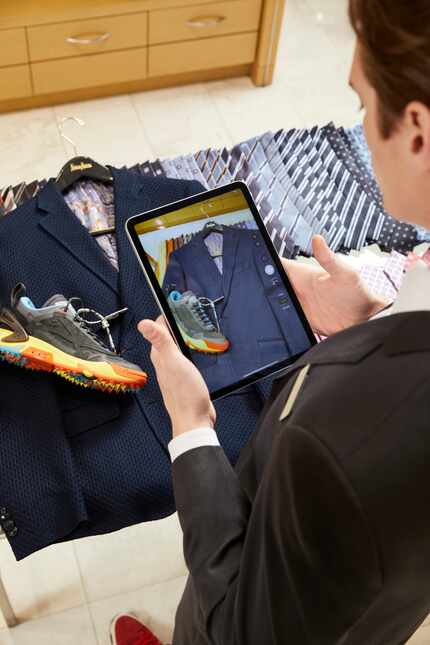 A Neiman Marcus men's stylist uses the Connect platform to help a customer shop remotely.