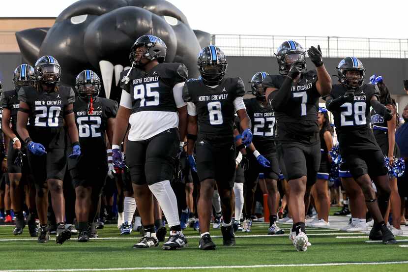 The North Crowley Panthers enter the field to face Euless Trinity in a high school football...