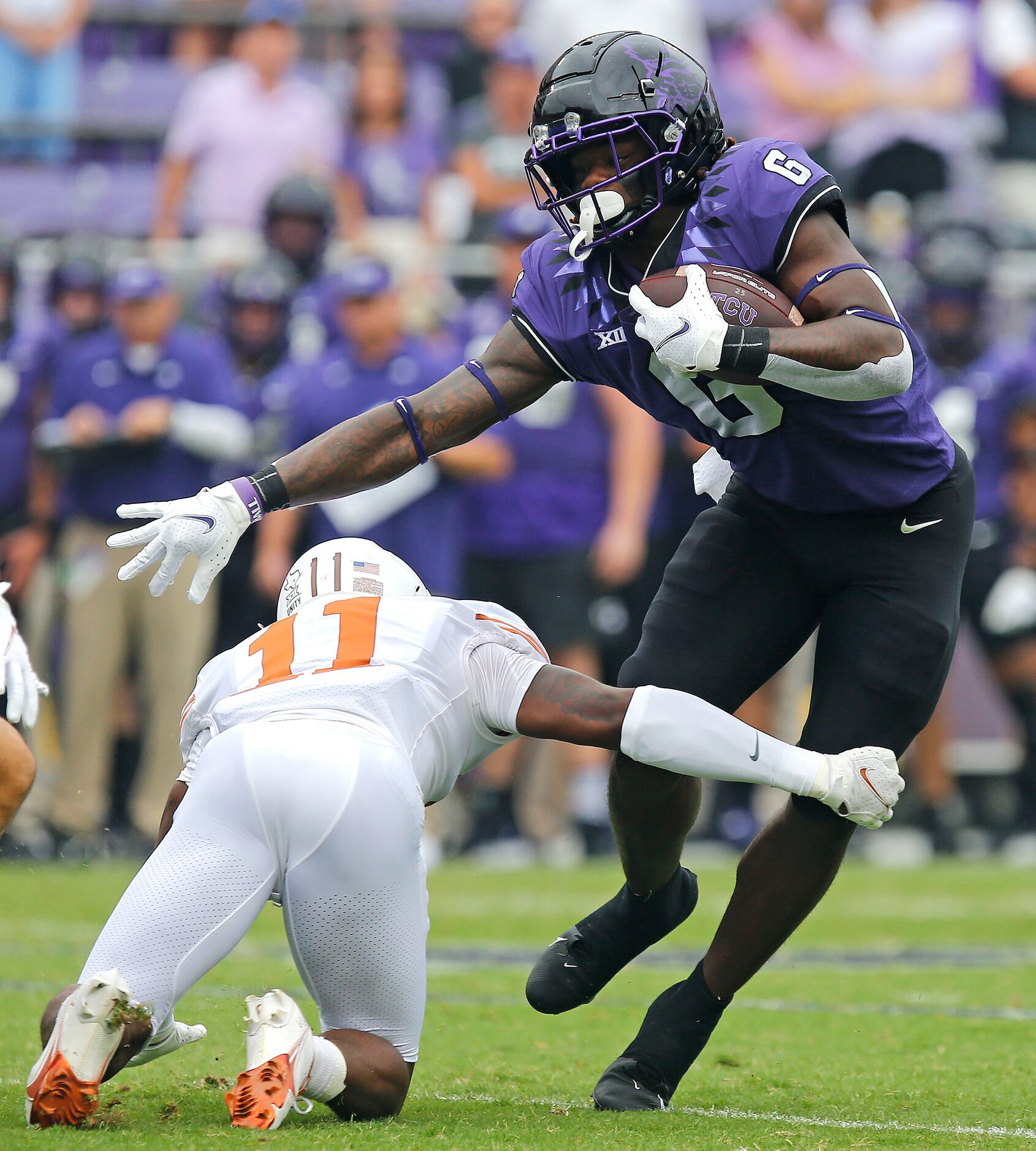 TCU Horned Frogs running back Zach Evans (6) breaks the tackle attempt by Texas Longhorns...