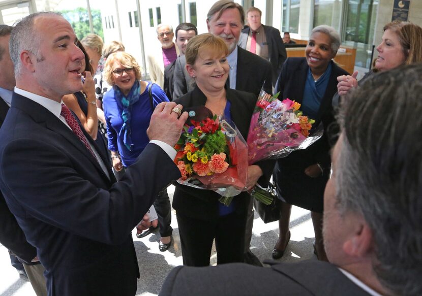 Former Judge Suzanne Wooten (center) was all smiles as she visited with her attorney Peter...