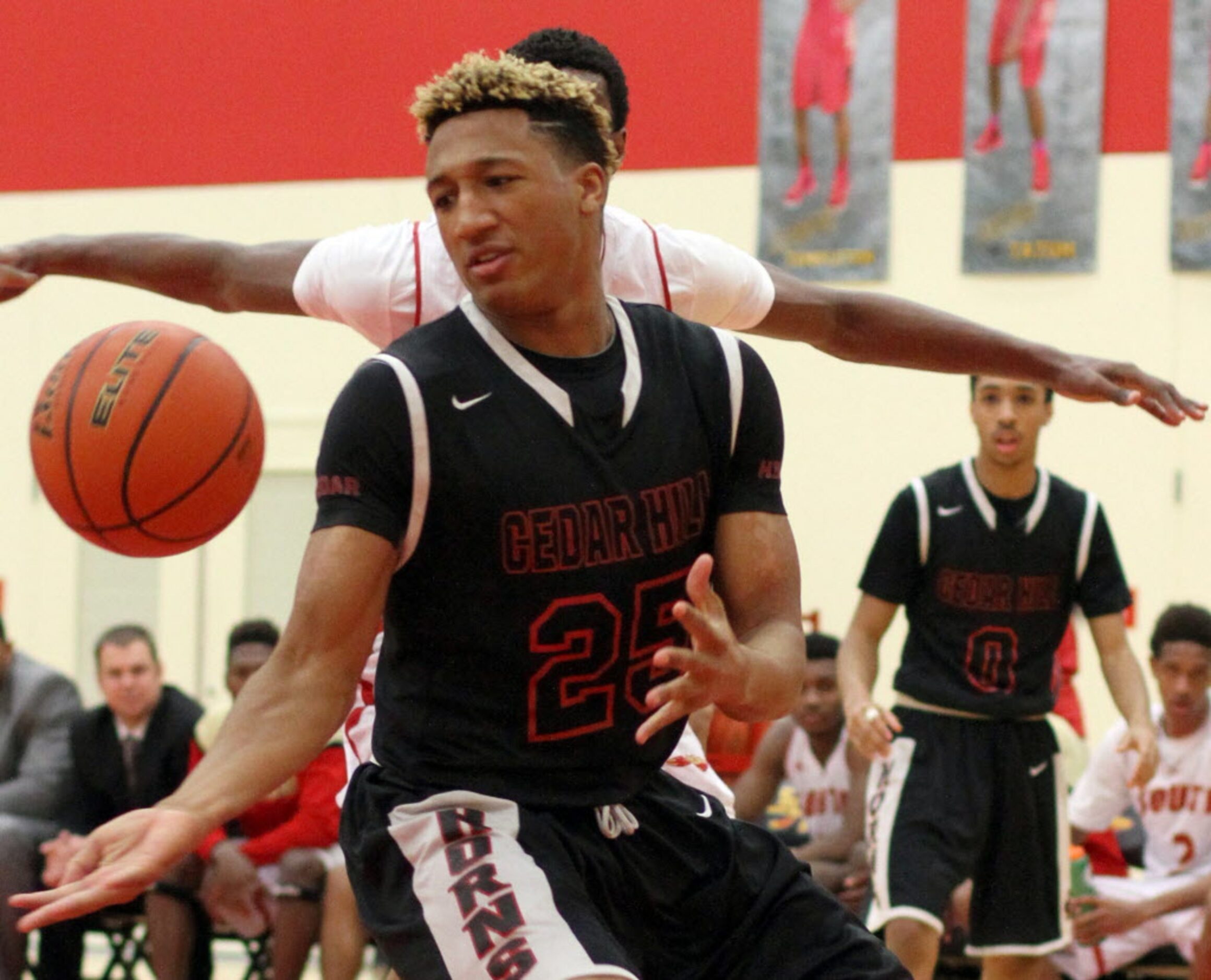 Cedar Hill forward Trevis Gipson (25) eyes the ball as a South Grand Prairie defender moves...