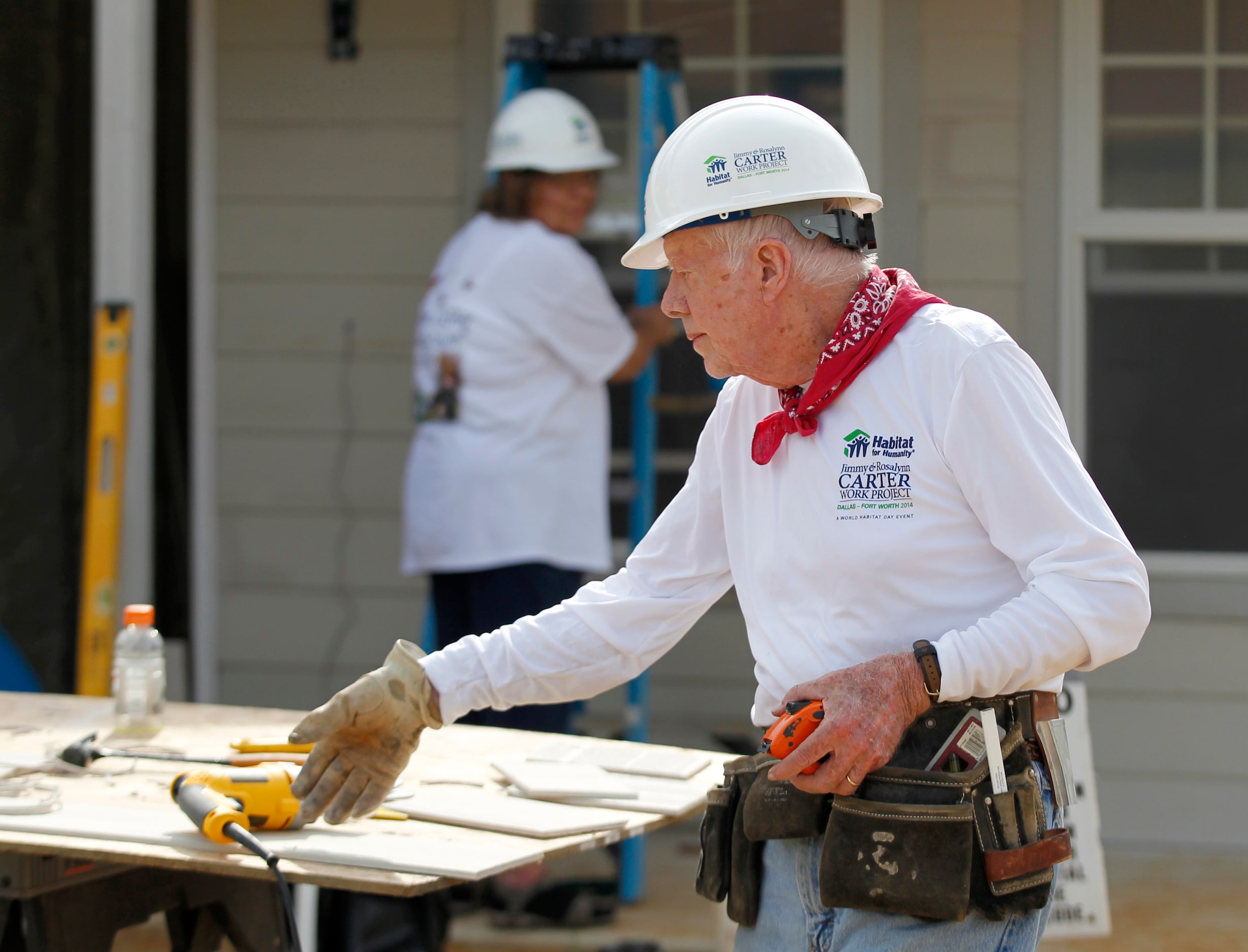 Former President Jimmy Carter, 90, works on the siding of a house for Habitat for Humanity,...