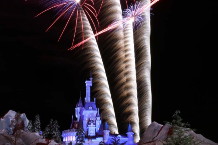 Fireworks blast over the Beast's Castle during a preview party at the New Fantasyland at...