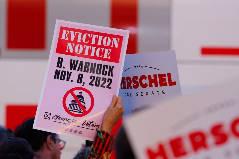 Attendees hold up signs as Herschel Walker, the Republican candidate for U.S. Senate in...