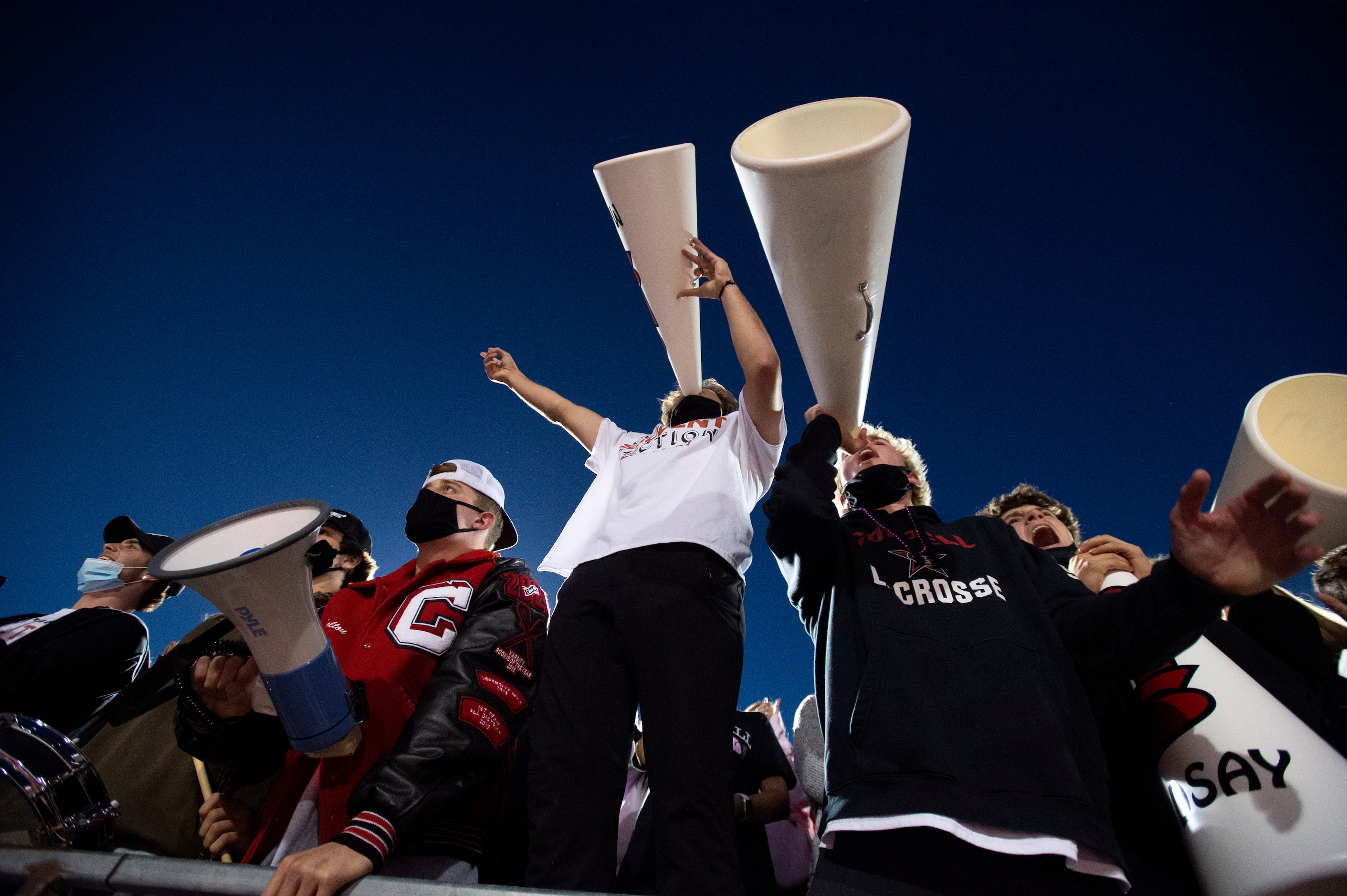 The Coppell students section cheers during the opening kickoff of a high school football...