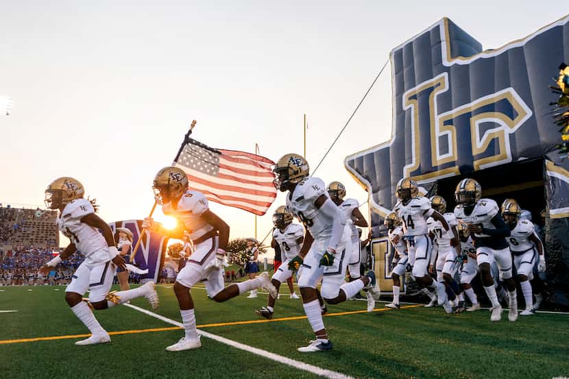 Little Elm takes the field before a high school football game against Plano West on Friday,...