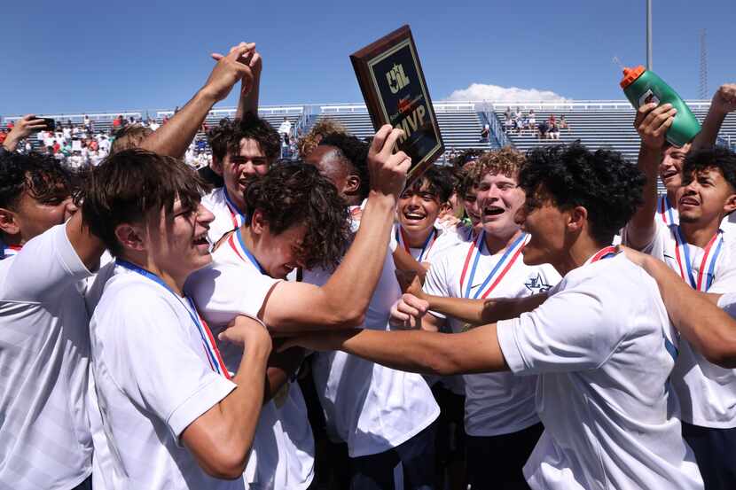 Frisco Lone Star players mob forward Bartek Zabek (11) after he was awarded the MVP plaque...