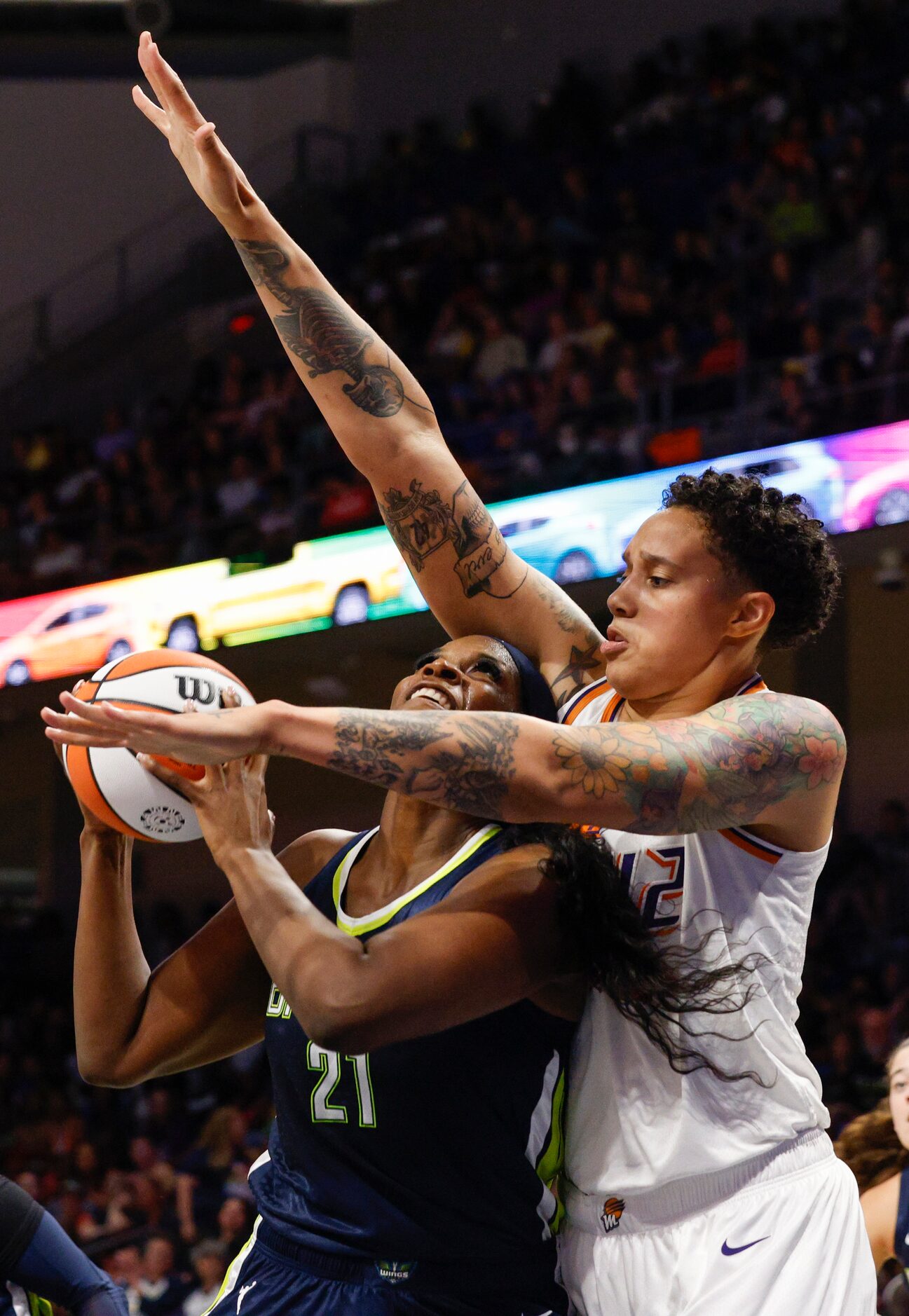 Phoenix Mercury center Brittney Griner (42) fouls Dallas Wings center Kalani Brown (21) as...