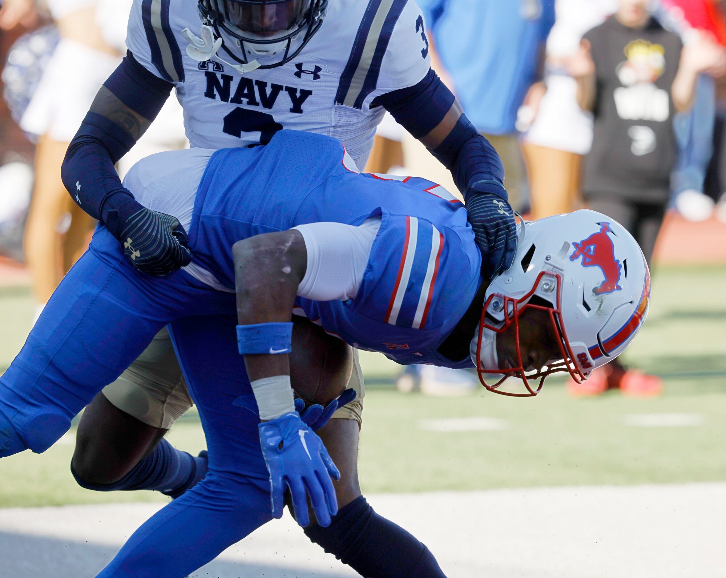 SMU wide receiver Moochie Dixon (5) scores a touchdown over Navy cornerback Elias Larry (3)...