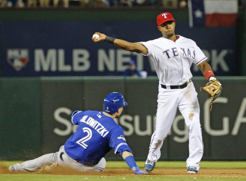 Texas Rangers shortstop Elvis Andrus (1) turns the pivot at second over Toronto Blue Jays...