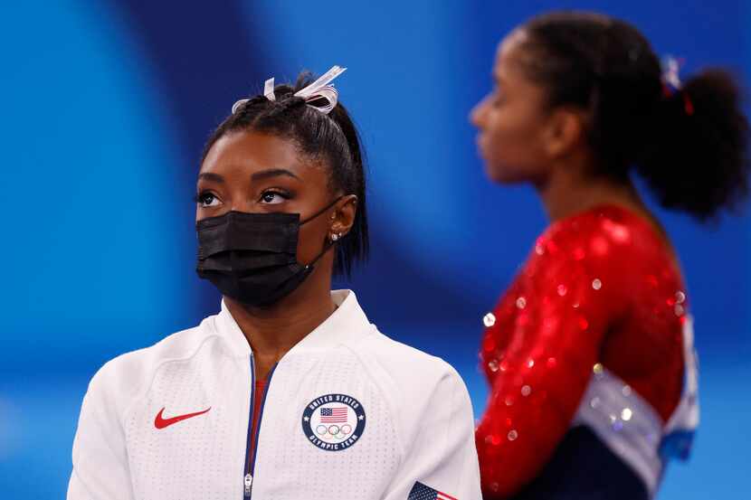 USA’s Simone Biles watches after pulling out of the competition after the vault event during...