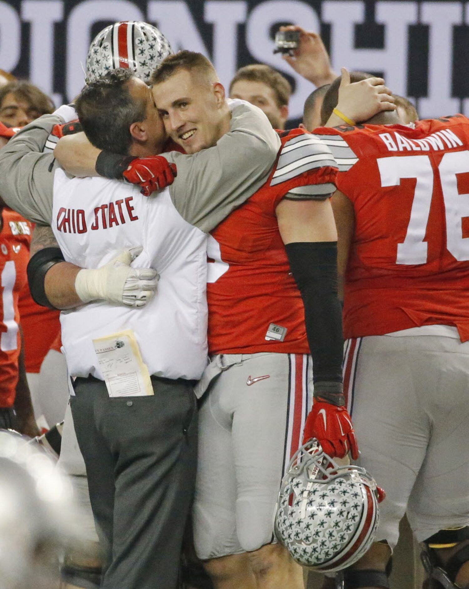 Tight end Jeff Heuerman (5) hugs head coach Urban Meyer as time runs out in the Buckeyes...