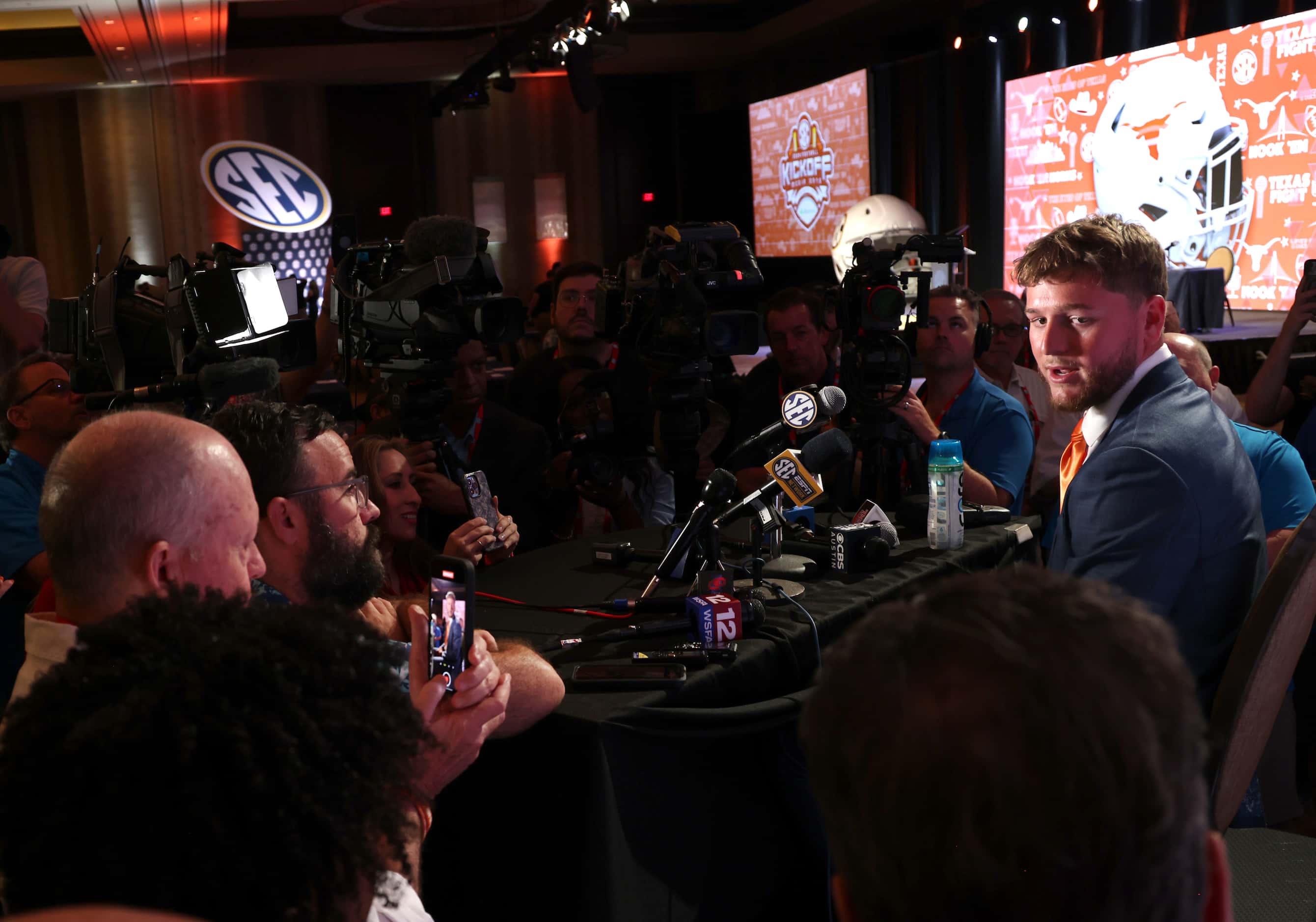 Texas Longhorns starting quarterback Quinn Ewers responds to a question from a media member...