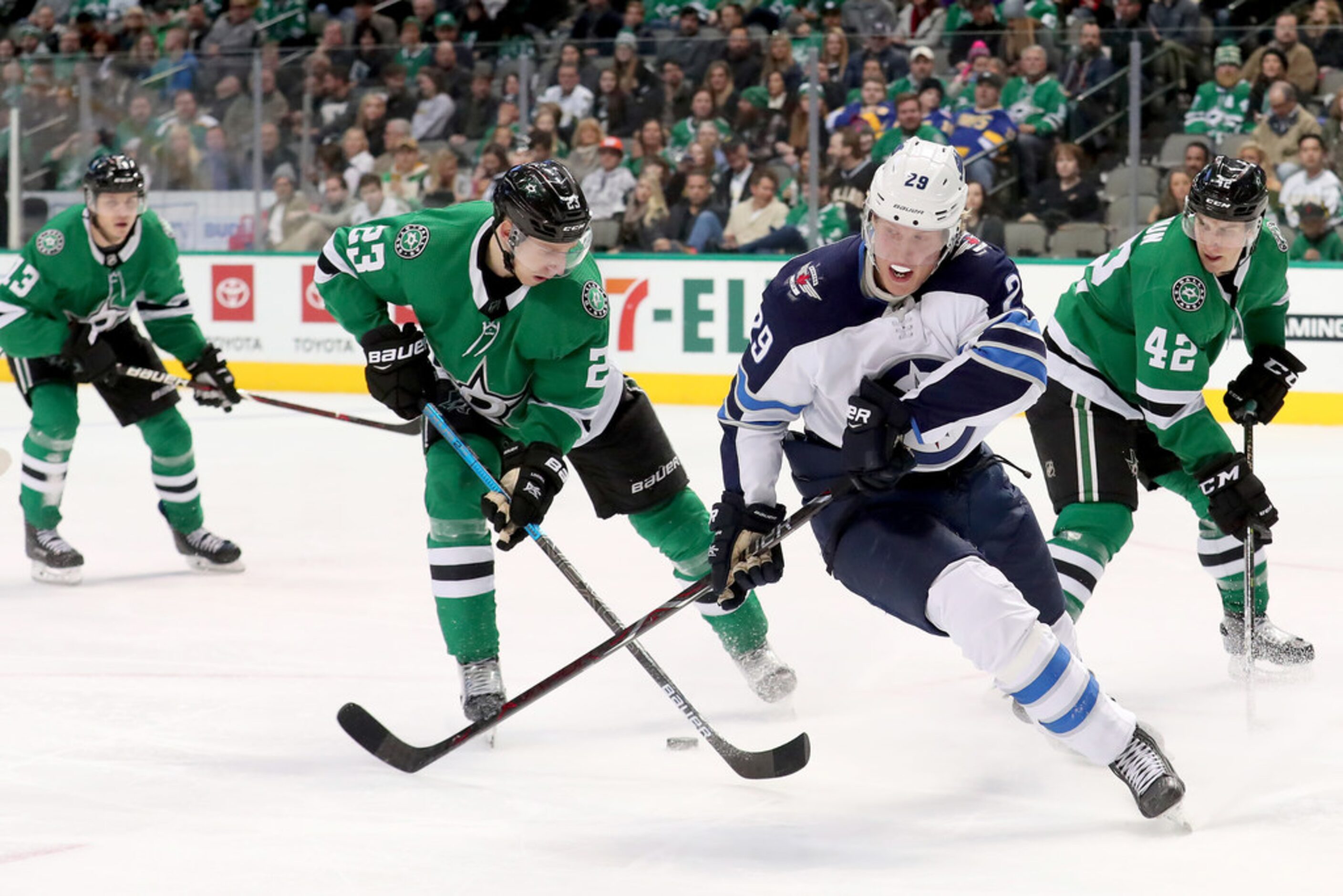 DALLAS, TEXAS - JANUARY 19: Esa Lindell #23 of the Dallas Stars controls the puck against...