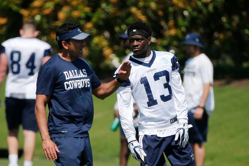 Dallas Cowboys wide receivers coach Sanjay Lal talks to receiver Michael Gallup (13) during...
