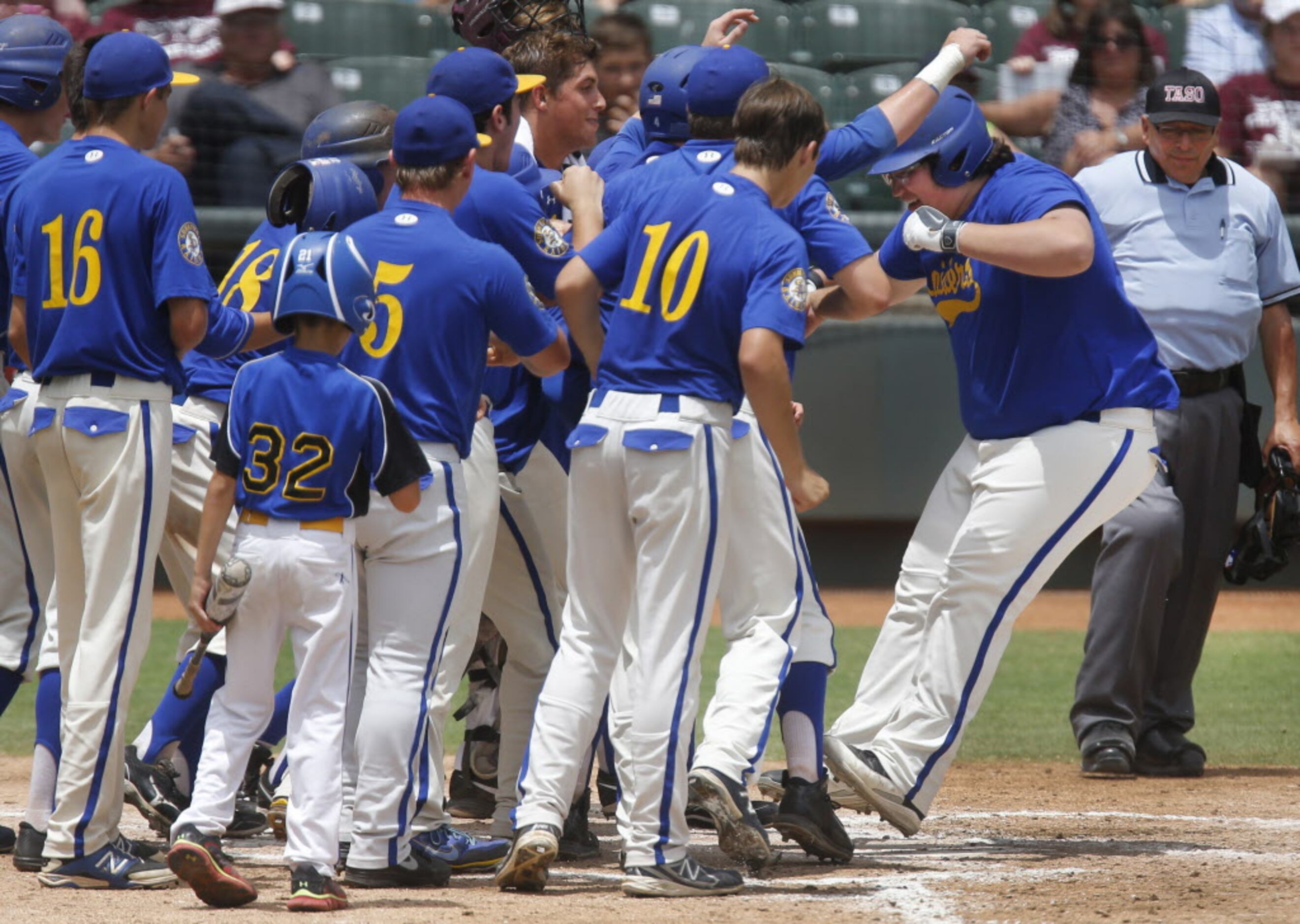 Sunnyvale's Seth Metzger jumps on home plate as he is greeted by jubilant teammates after...