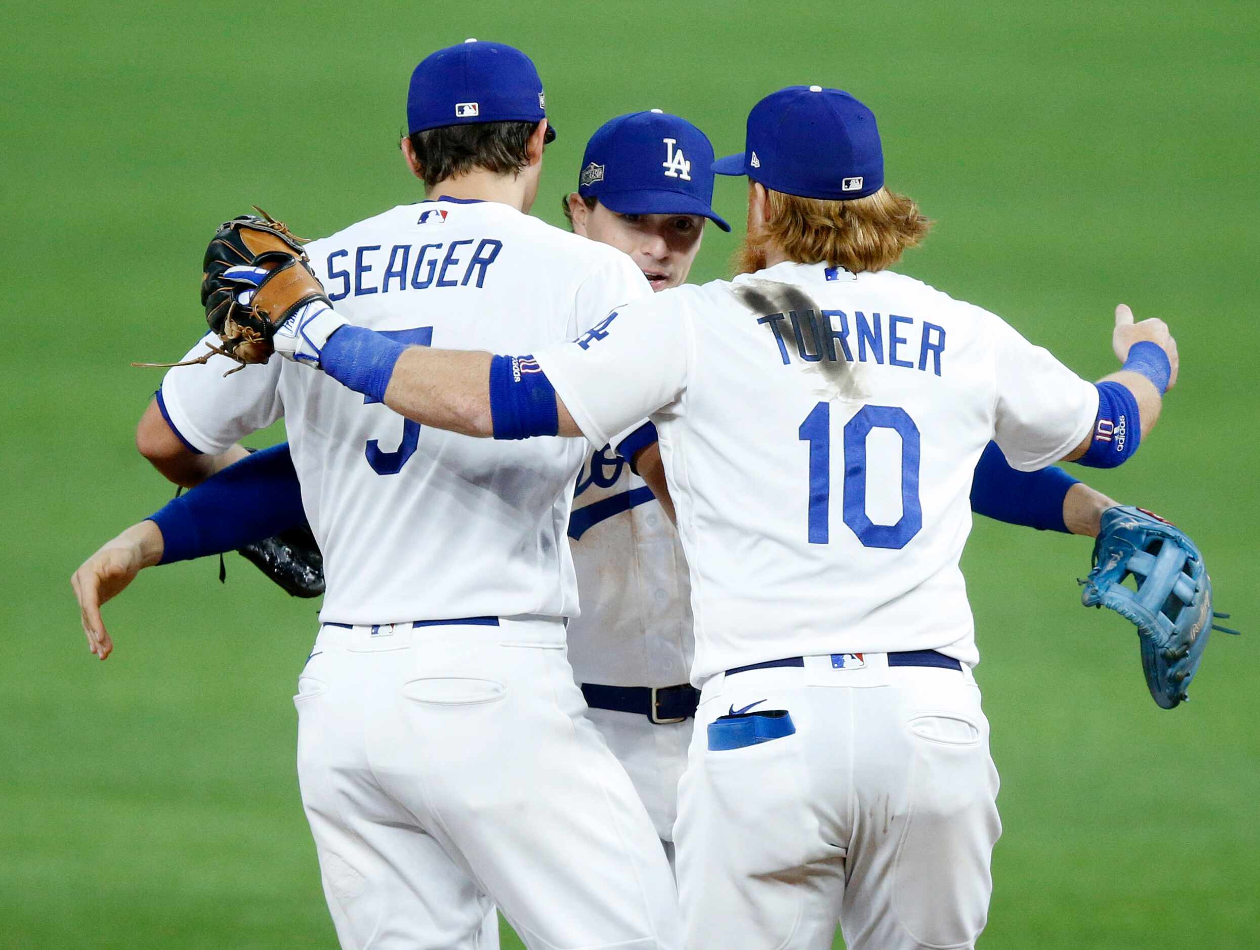 Los Angeles Dodgers shortstop Corey Seager (5), third baseman Justin Turner (10) and second...