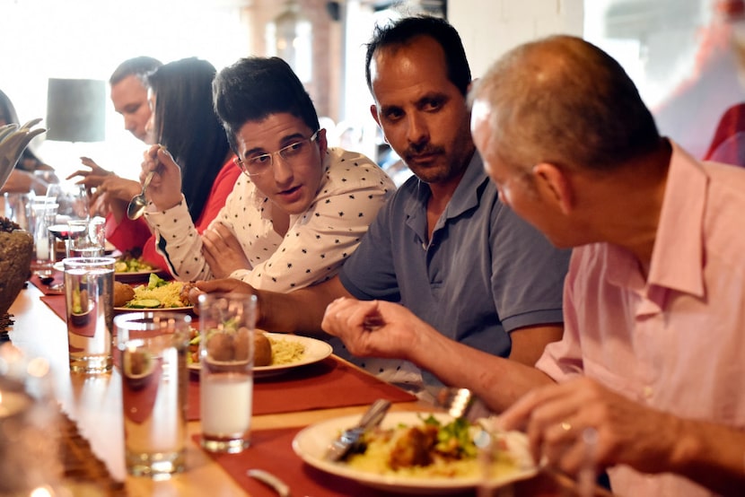 Mohamad Al Khen amd Abdul Salam Aleid speak to dinner guests during a fundraising dinner for...