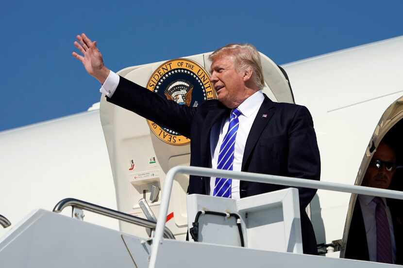 President Donald Trump waves during his arrival at Bismark Municipal Airport, Wednesday,...
