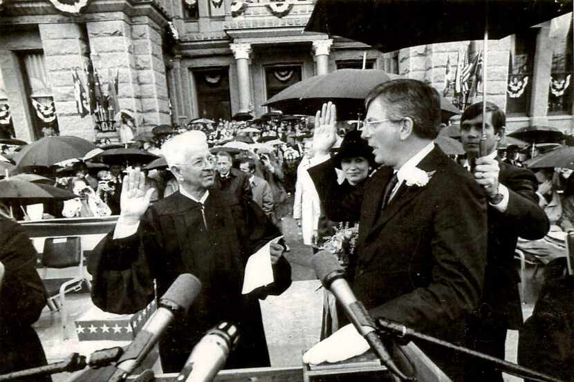 AUSTIN, TEXAS - January 18, 1983 - Texas Governor Mark Wells White (right) takes the oath of...