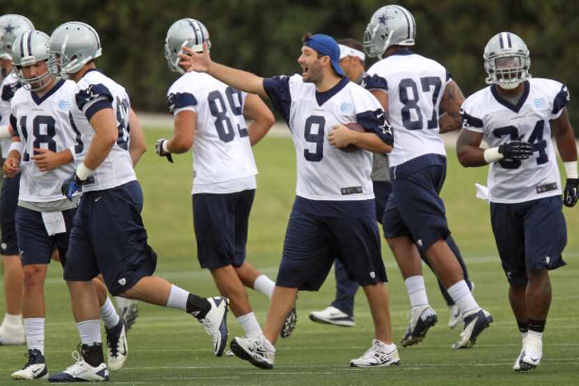 Dallas quarterback Tony Romo (9) directs teammates during the Dallas Cowboys first OTA...