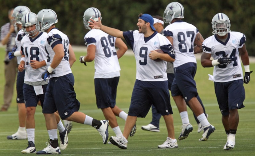 Dallas quarterback Tony Romo (9) directs teammates during the Dallas Cowboys first OTA...