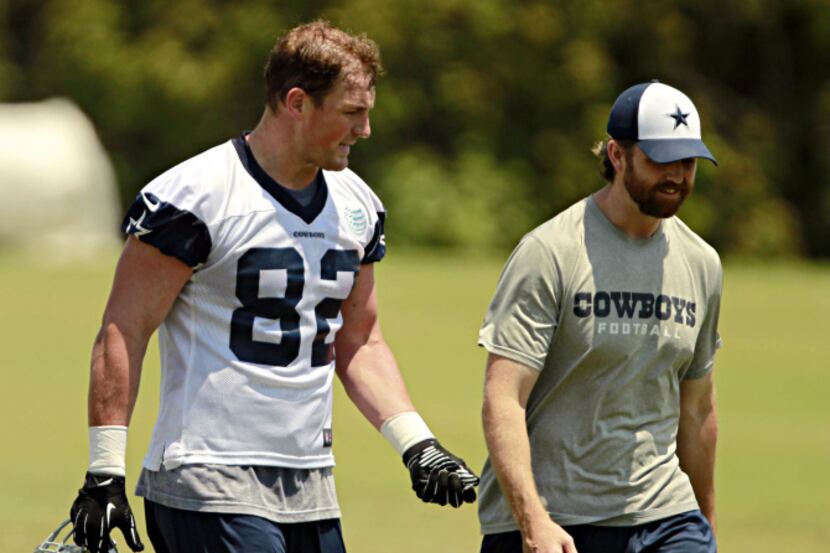 Dallas Cowboys tight end Jason Witten (82) talks with coach Wes Phillips as they walk off...