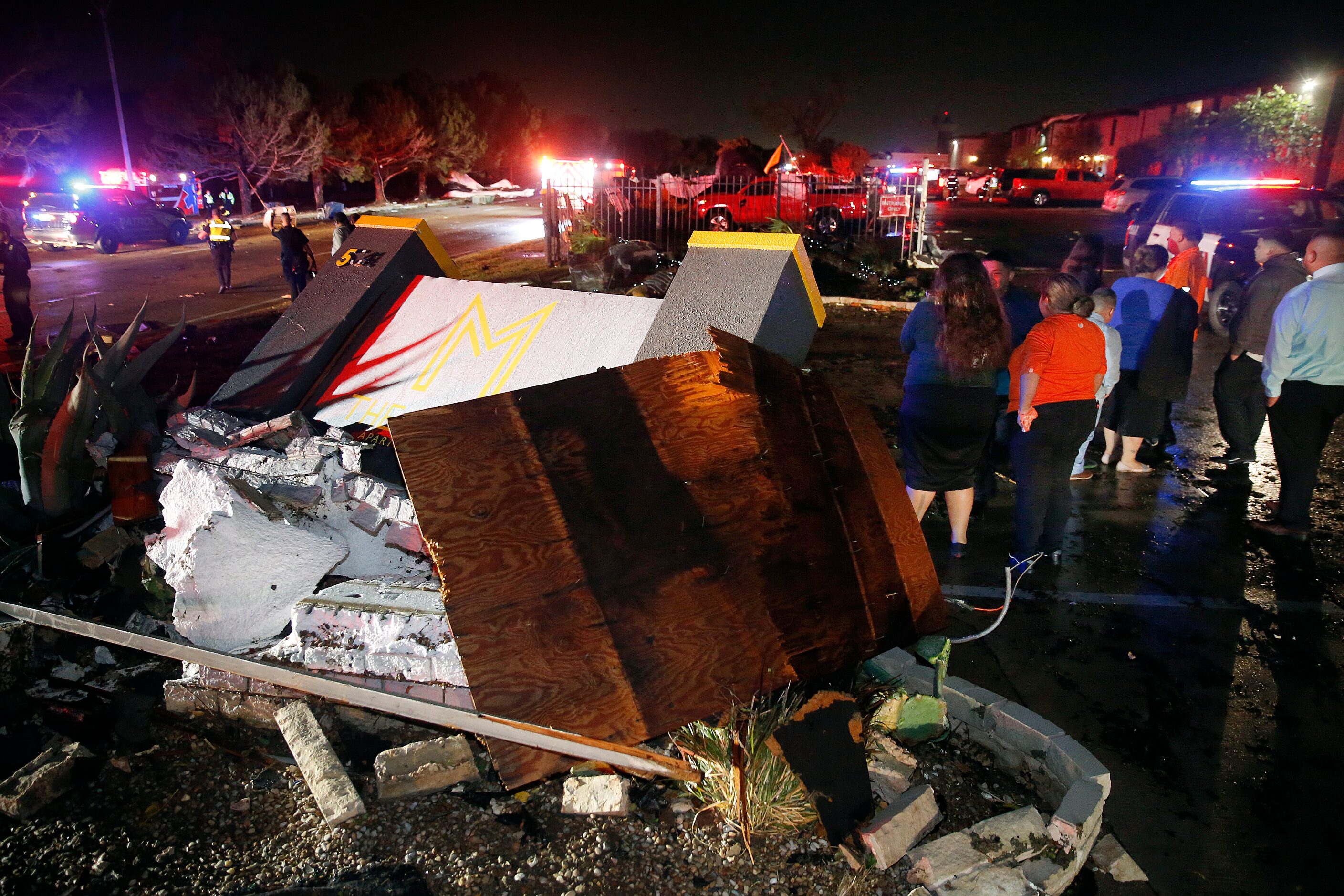 The Mirage Apartments sign lies damaged along Pioneer Parkway in Arlington as people came...