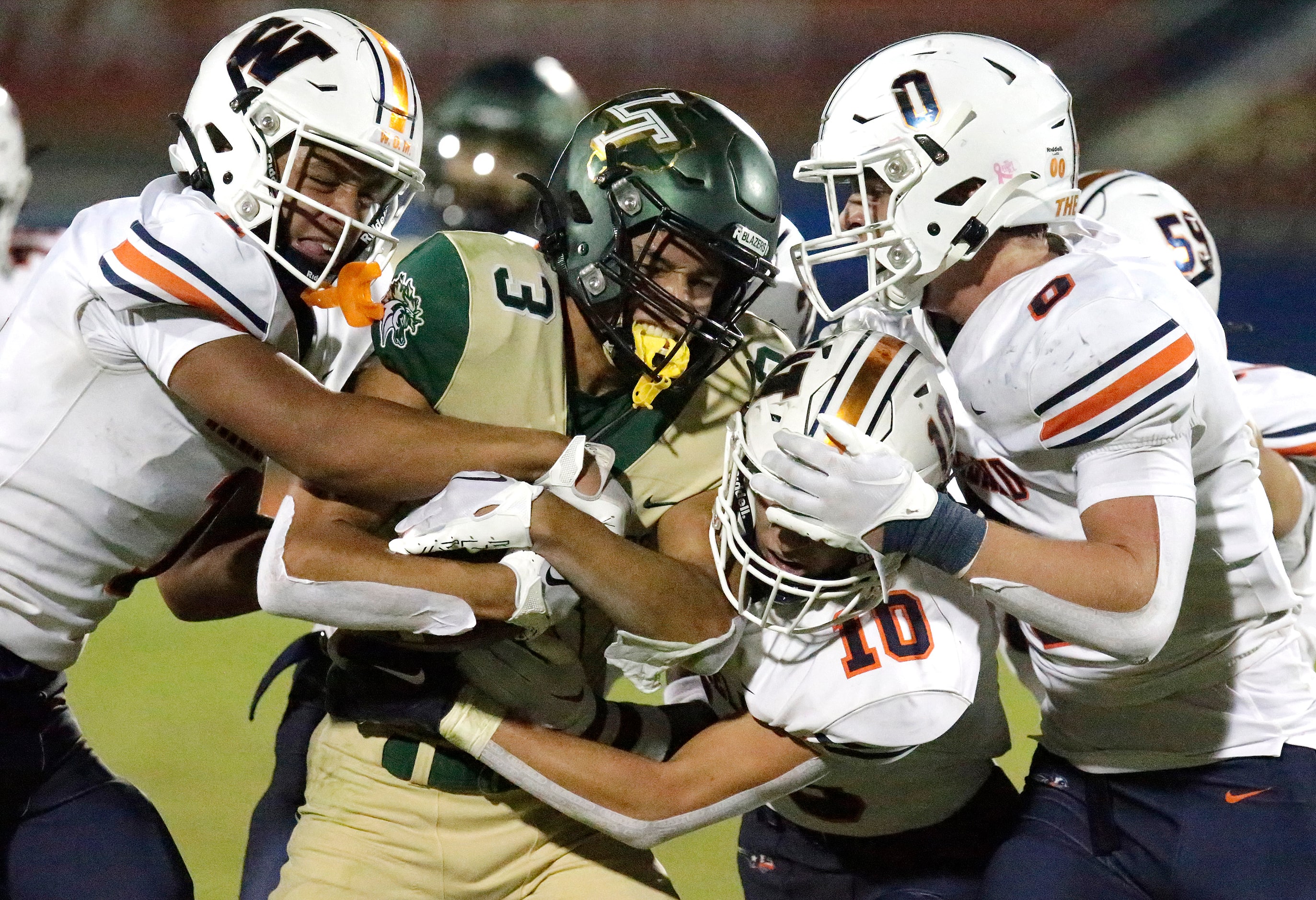 Wakealnd High School linebacker Donovan Woolen (1), Wakealnd High School safety Grayson Myer...