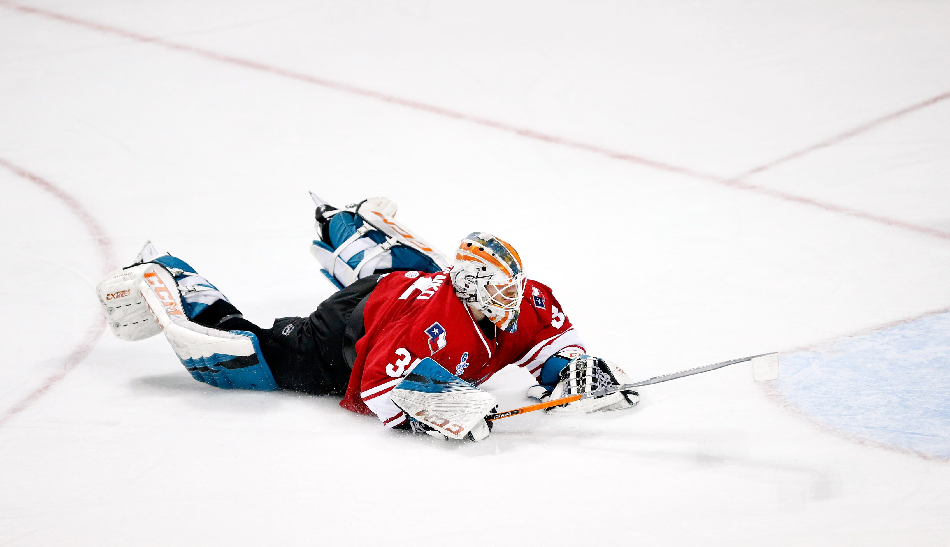 Allen Americans goalie Zach Sawchenko (34) dives at a Rapid City Rush shot during the second...