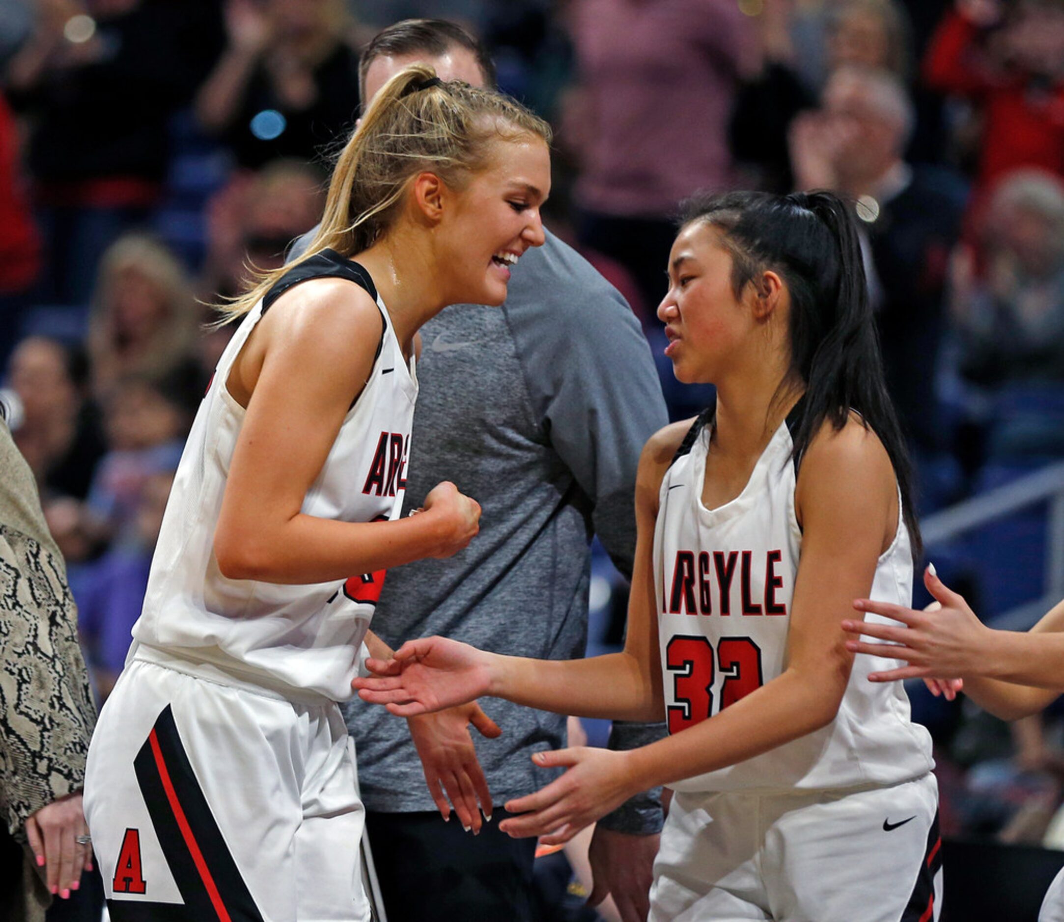 Argyle forward Shelby Henches #35 is congratulated by teammate Argyle guard Madi Lumsden #32...