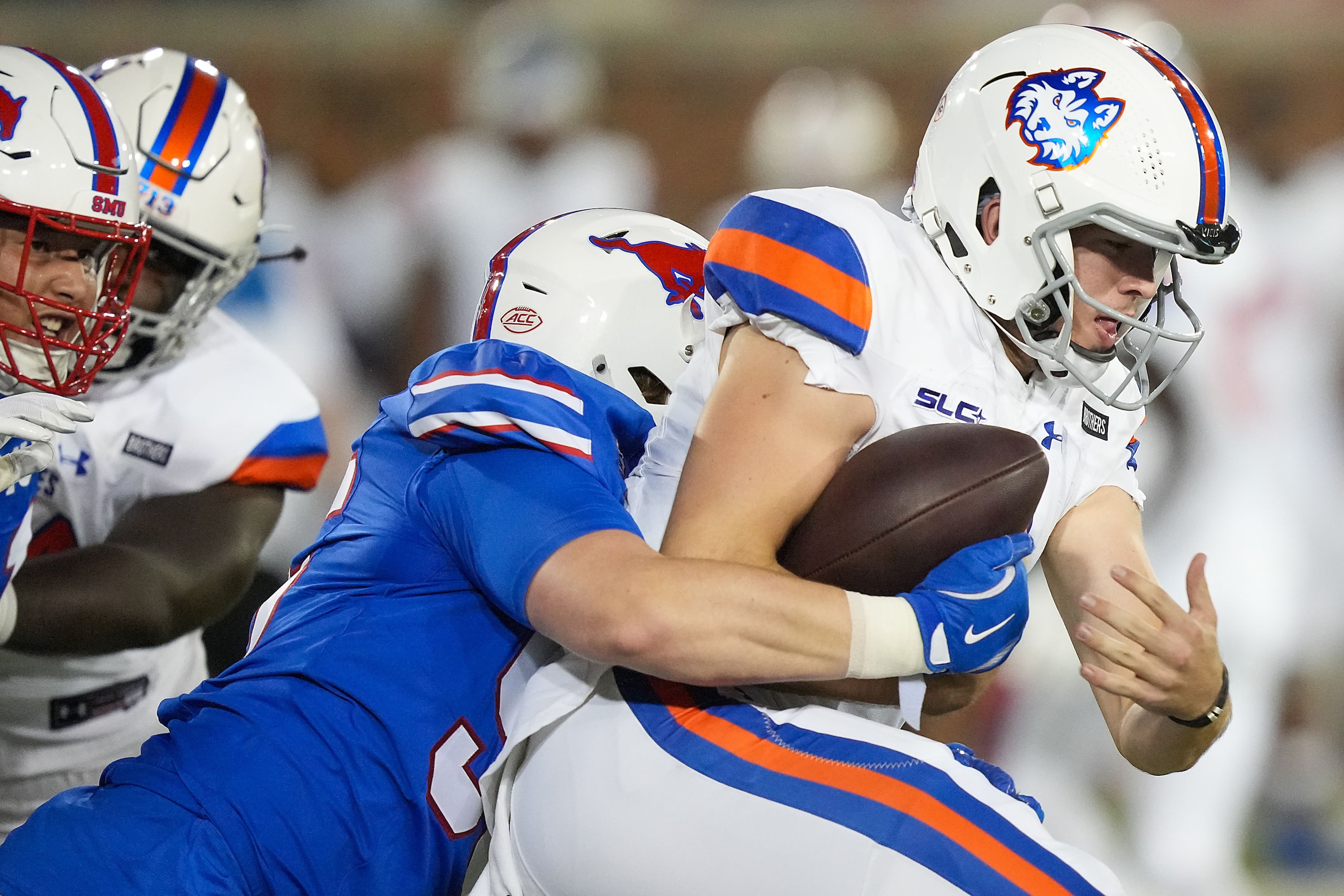 Houston Christian quarterback Eli Brickhandler (3) is sacked by SMU defensive end Matt Baer...