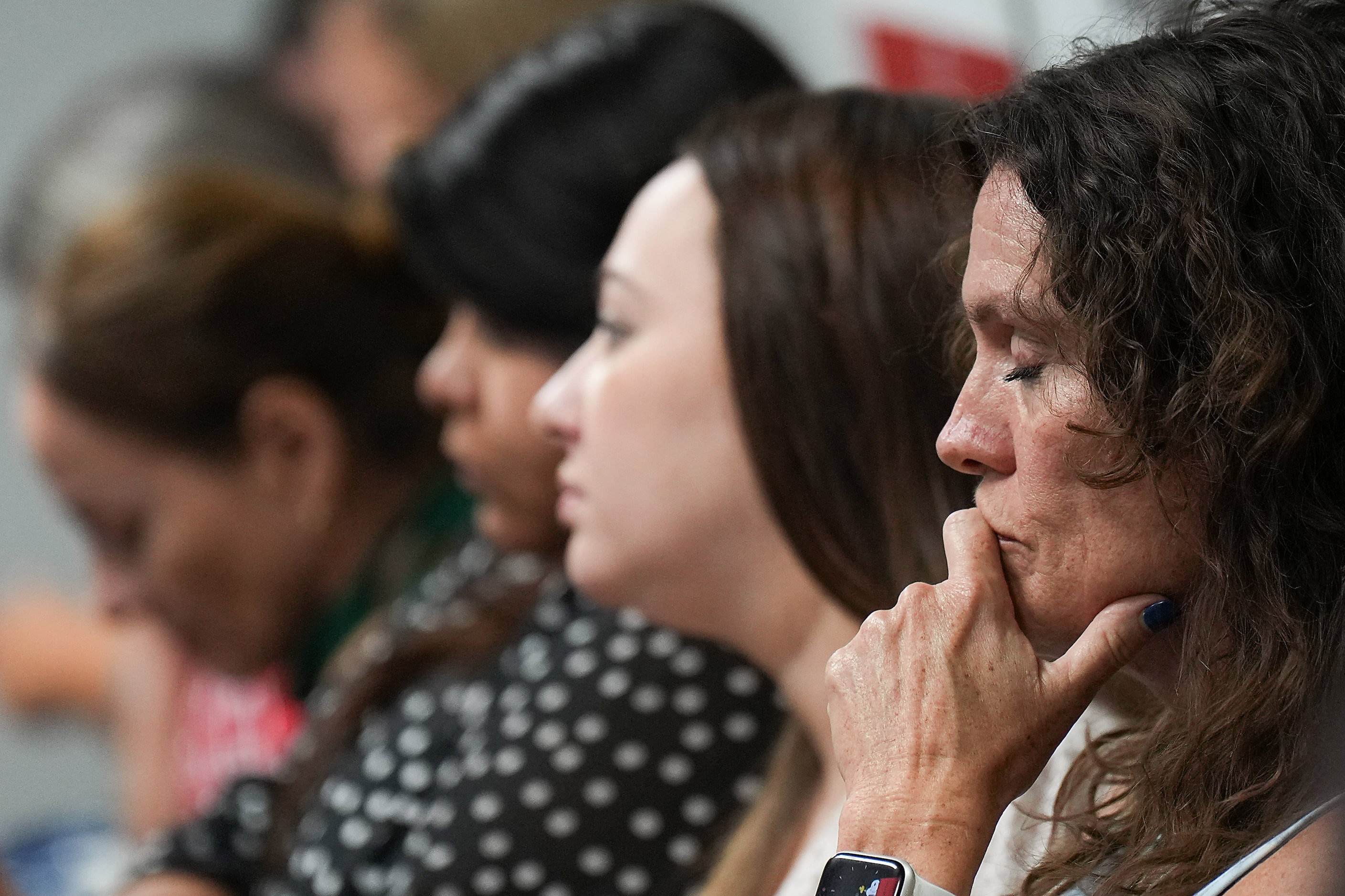 People in the audience listen to discussion on the closing of Pinkerton Elementary during...