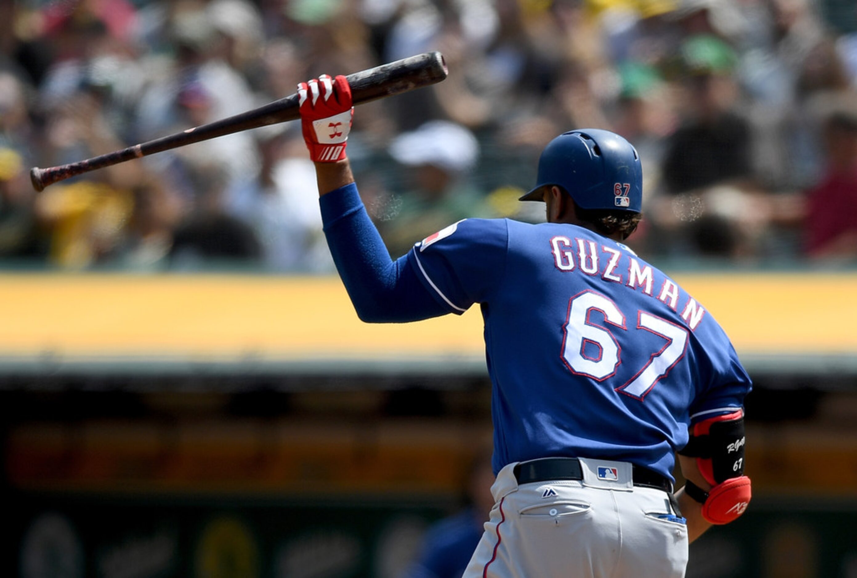 OAKLAND, CA - AUGUST 22:  Ronald Guzman #67 of the Texas Rangers reacts to slam his bat to...