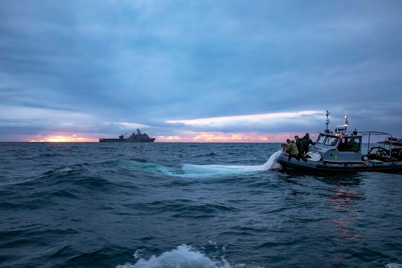 This image provided by the U.S. Navy shows sailors assigned to Explosive Ordnance Disposal...