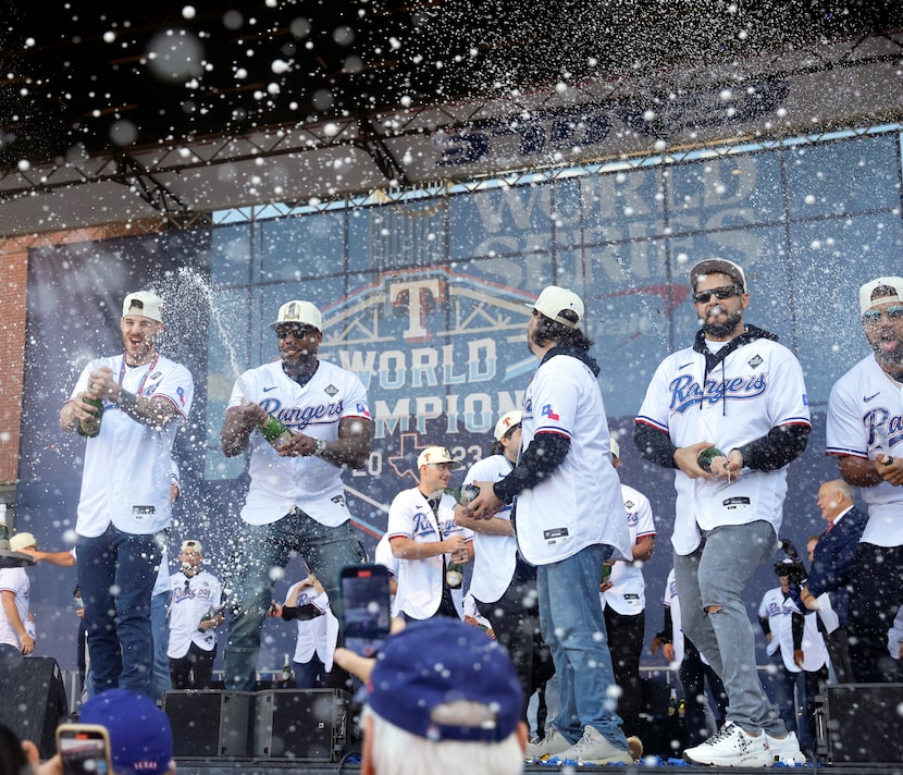 Texas Rangers players spray the crowd with champagne following their World Series Victory...