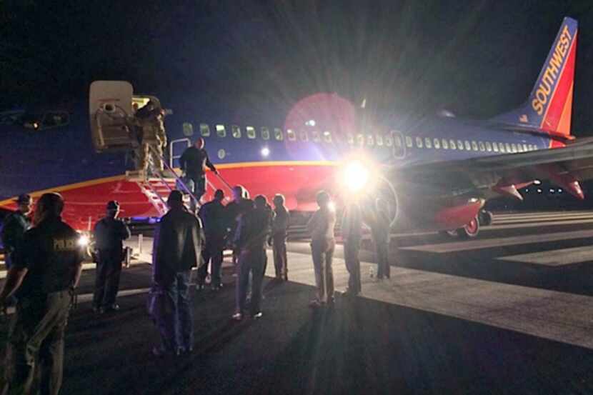 Passengers exit a Southwest Airlines flight that was supposed to land at Branson Airport in...