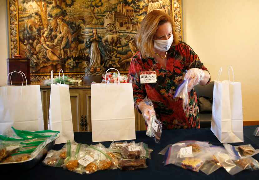 Shannon Callewart works on filling goodie bags in the parlor at Saint Michael and All Angels...