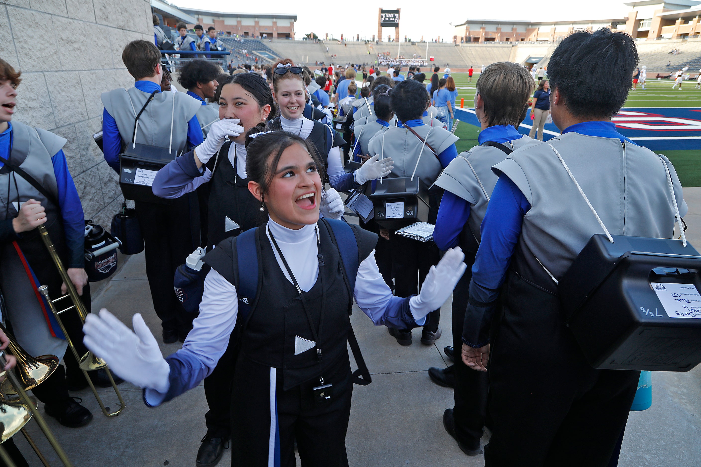 Valeria Gasca, 17, drum major for the Allen High School marching band, greets fellow band...