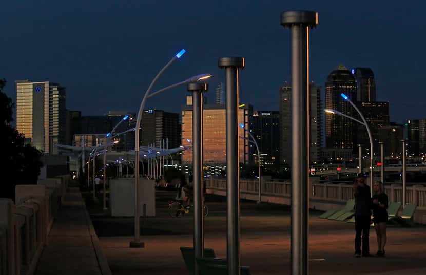 Blue LEDs sit atop the streetlights around the Trinity River at the Ronald Kirk Pedestrian...