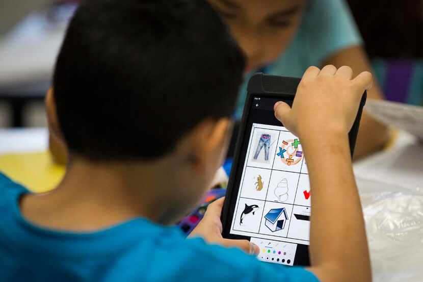 Students work on iPad tablets in a second grade class at Shands Elementary in September,...
