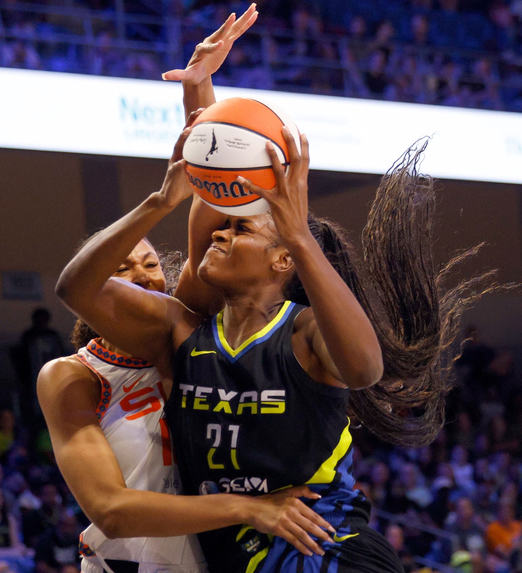 Dallas Wings center Kalani Brown (21) tries to shoot over Connecticut Sun forward Olivia...