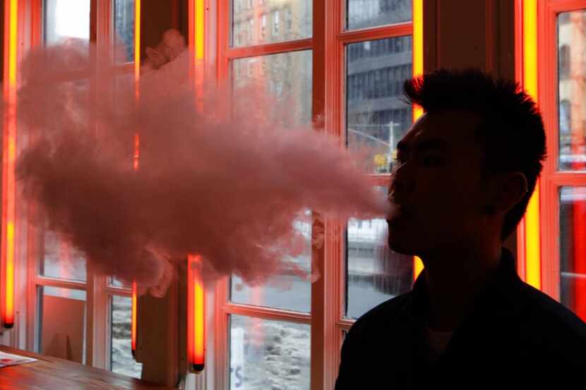 A patron  exhales vapor from an e-cigarette at the Henley Vaporium in New York last year.