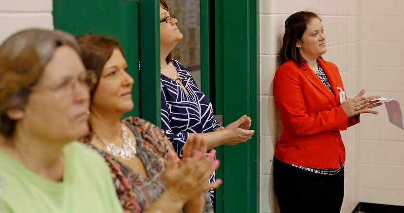 
Jana Everett (right) stands near kitchen server Vicki Littlefield (from left) and teacher...