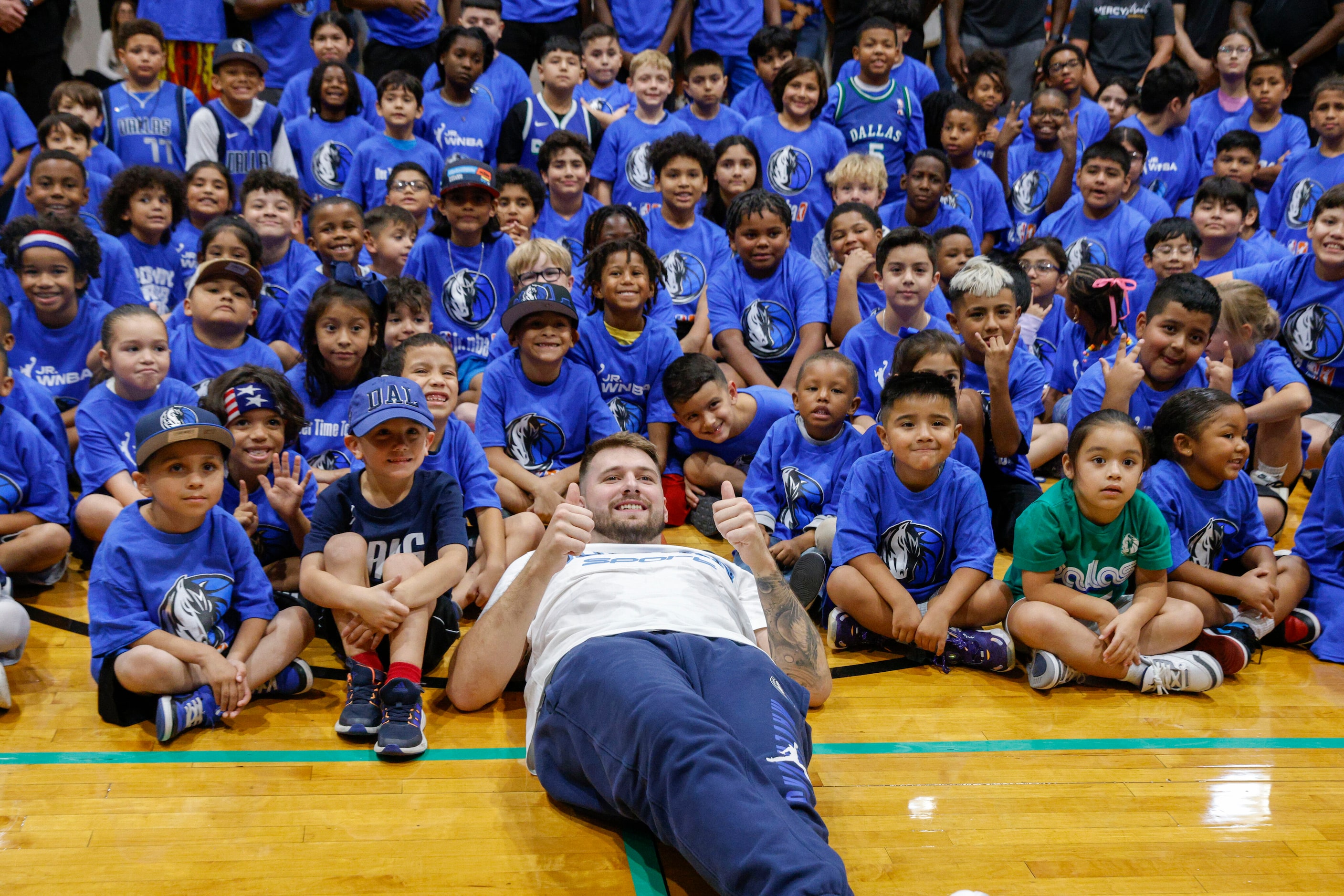 Dallas Mavericks guard Luka Doncic poses for photos after a children’s basketball clinic,...