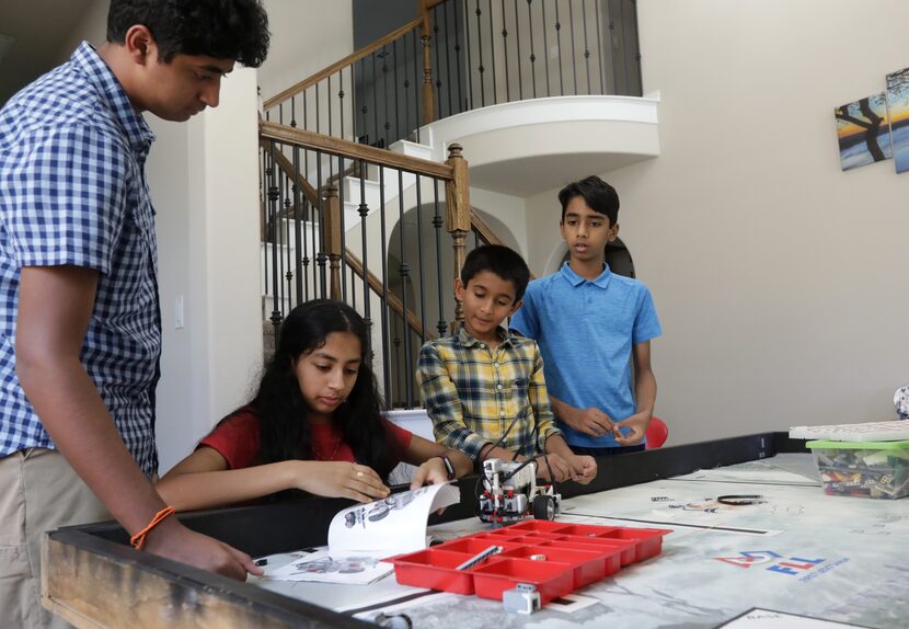 Mihit Sai Garlanka (from left) assists 13-year-old Samriddhi Garlanka, 11-year-old Santhosh...