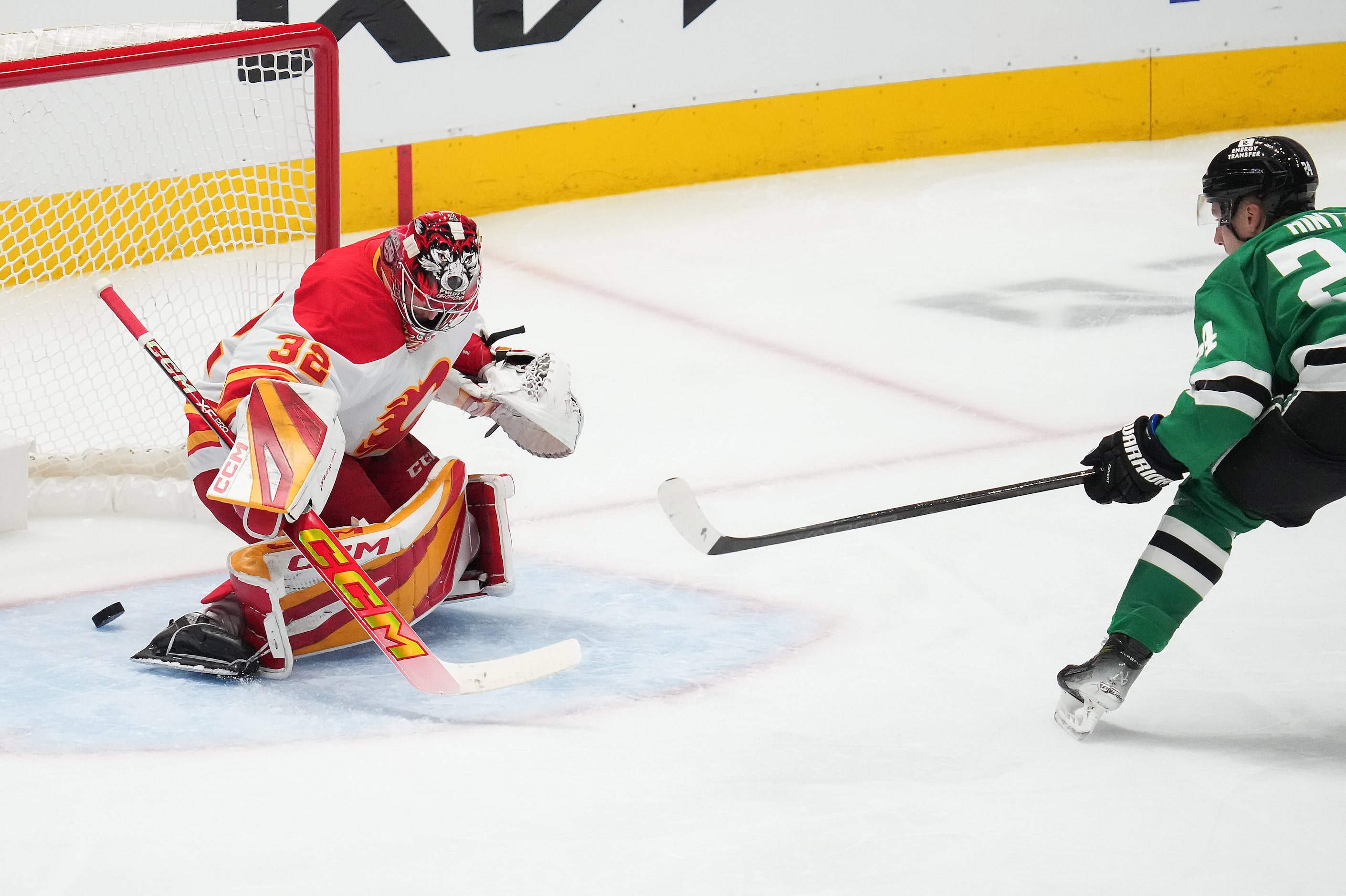 Dallas Stars center Roope Hintz (24) beats Calgary Flames goaltender Dustin Wolf (32) for a...