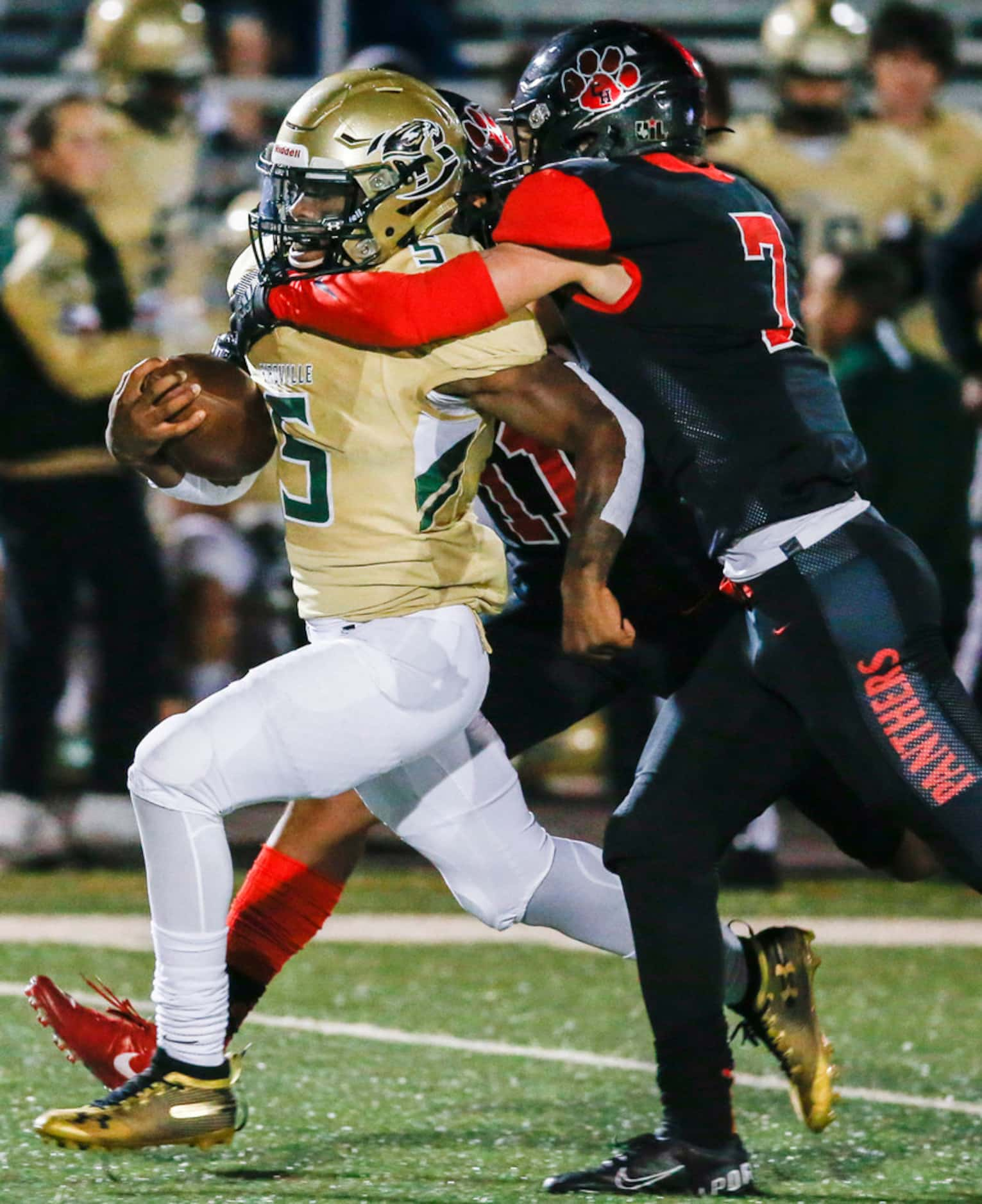 Colleyville Heritage defensive back Joshua Dobbins (11) and safety Luke Made (7) work to...